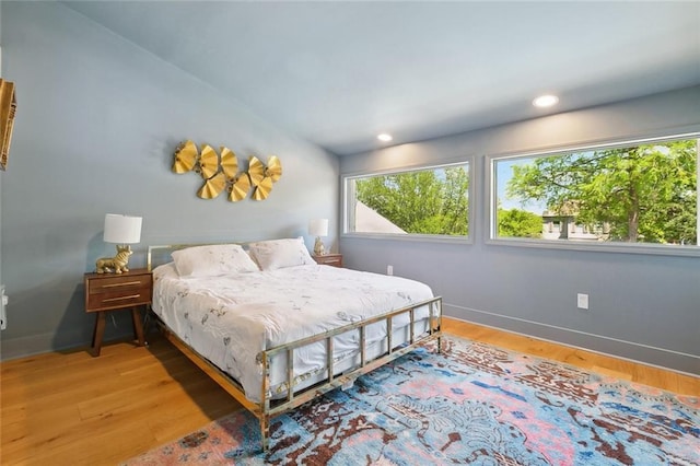 bedroom with light wood-style floors, recessed lighting, and baseboards