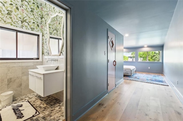 bathroom featuring vanity, baseboards, and hardwood / wood-style floors