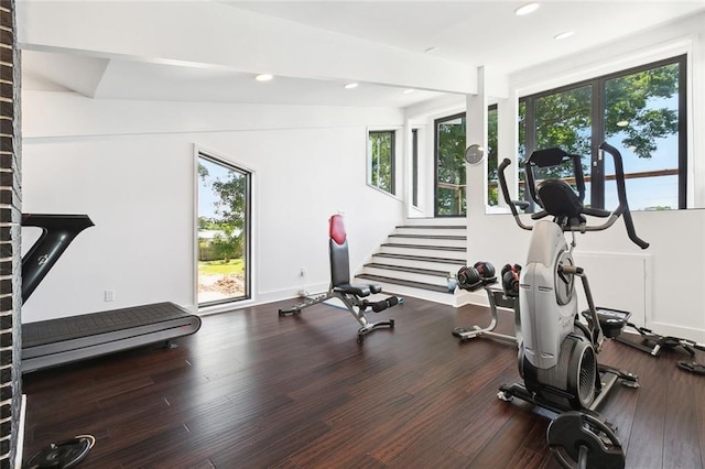 exercise room with recessed lighting and wood finished floors