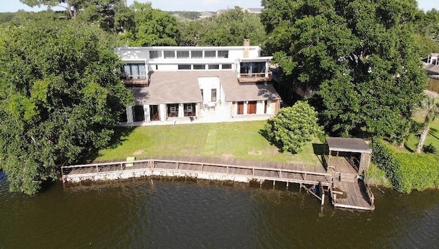 5640 Bancroft Dr, New Orleans, LA 70122 - rear view of property featuring stucco siding, a water view, and a yard