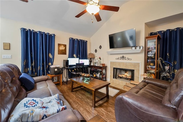 living room featuring high vaulted ceiling, ceiling fan, a fireplace, and wood finished floors