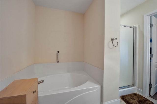 full bathroom with a shower stall and a bath