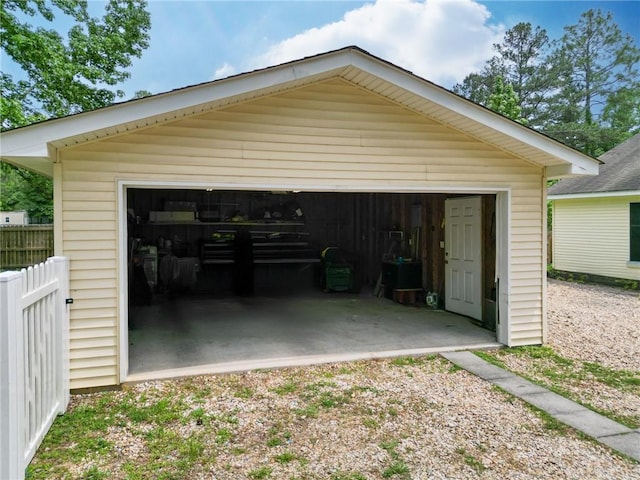 detached garage featuring fence
