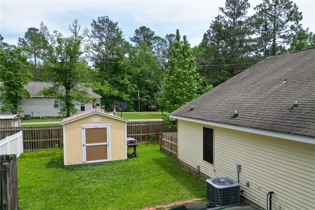 view of shed with a fenced backyard and central AC unit