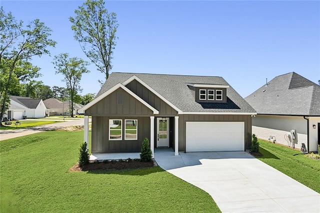 1025 Abita River Dr E, Covington, LA 70433 - view of front of house with board and batten siding, concrete driveway, a front lawn, and a garage