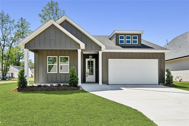 1025 Abita River Dr E, Covington, LA 70433 - view of front facade with board and batten siding, a front yard, a garage, driveway, and a shingled roof