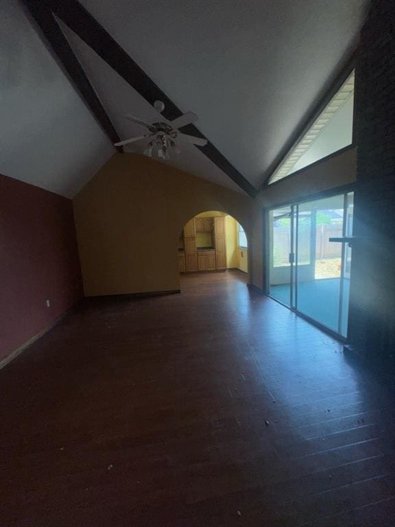bonus room with ceiling fan, arched walkways, wood finished floors, baseboards, and high vaulted ceiling