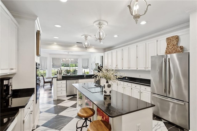 kitchen featuring a sink, dark countertops, black appliances, and a chandelier