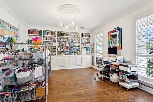 home office with crown molding, a notable chandelier, plenty of natural light, and wood finished floors