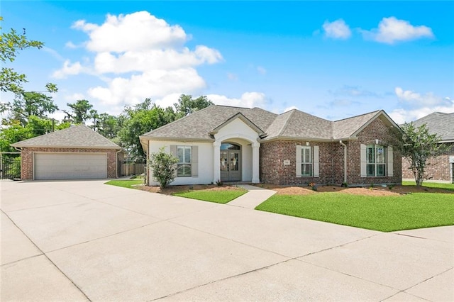 view of front facade with french doors, a front yard, roof with shingles, brick siding, and fence
