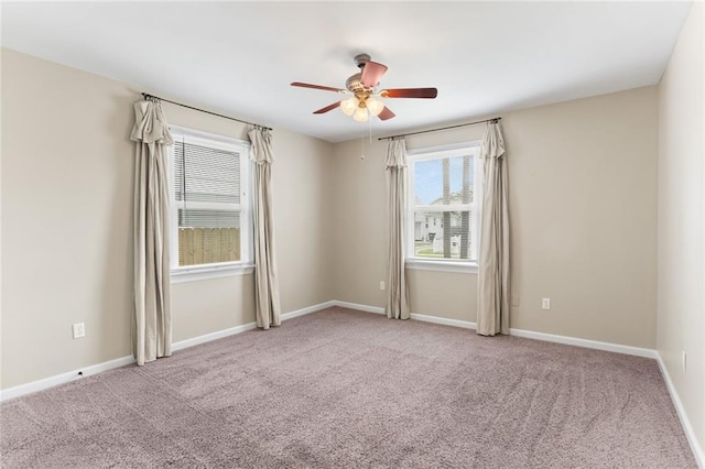 empty room featuring carpet flooring, ceiling fan, and baseboards