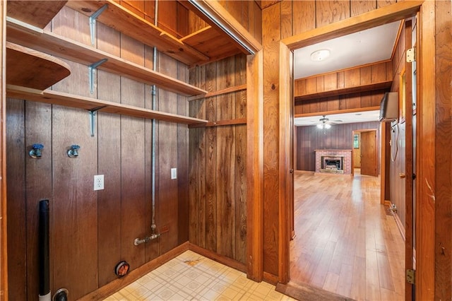 328 E St, Mandeville, LA 70448 - interior space featuring a ceiling fan, wood walls, wood finished floors, and a fireplace