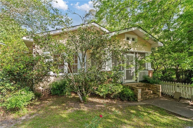 328 E St, Mandeville, LA 70448 - view of front facade with fence and a sunroom
