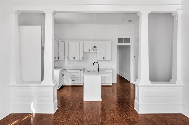 180002 Franklin Ave, New Orleans, LA 70117 - kitchen with a kitchen island with sink, dark wood-style floors, decorative light fixtures, and white cabinetry