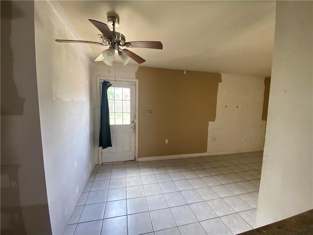 unfurnished room featuring light tile patterned floors, baseboards, and ceiling fan