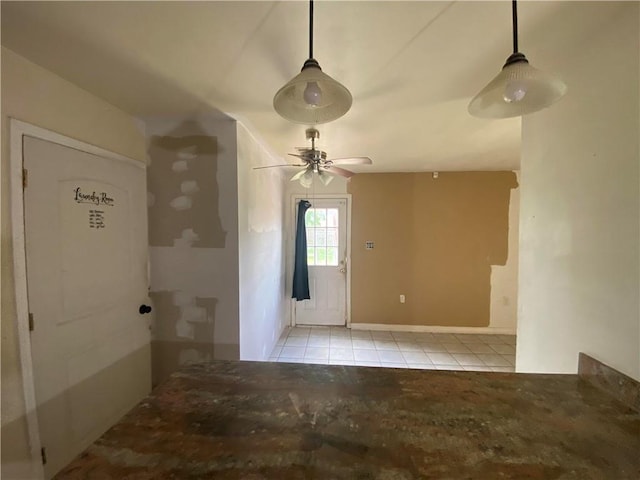 spare room featuring ceiling fan and light tile patterned floors
