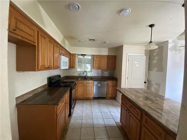 kitchen featuring black / electric stove, brown cabinets, dishwasher, a sink, and white microwave