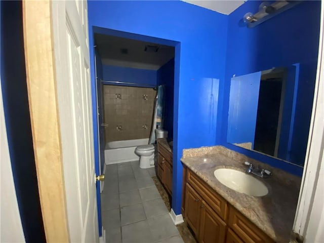 full bathroom featuring tile patterned flooring, bathing tub / shower combination, toilet, and vanity