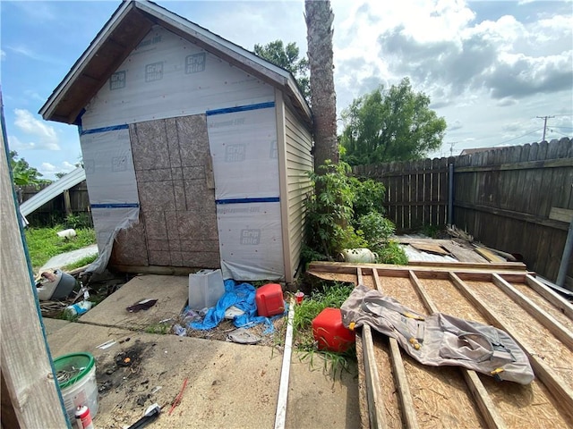 view of shed featuring fence
