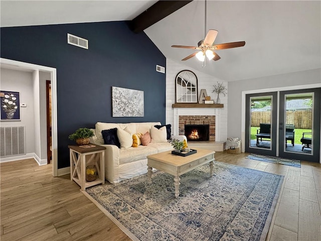 living area featuring a ceiling fan, wood finished floors, and visible vents