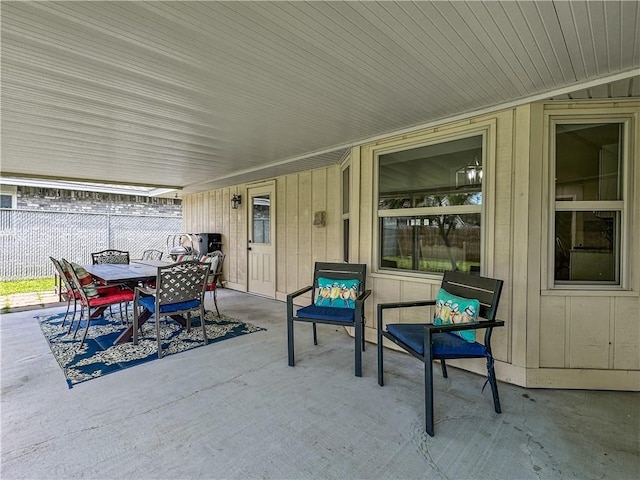 view of patio / terrace featuring outdoor dining area and fence