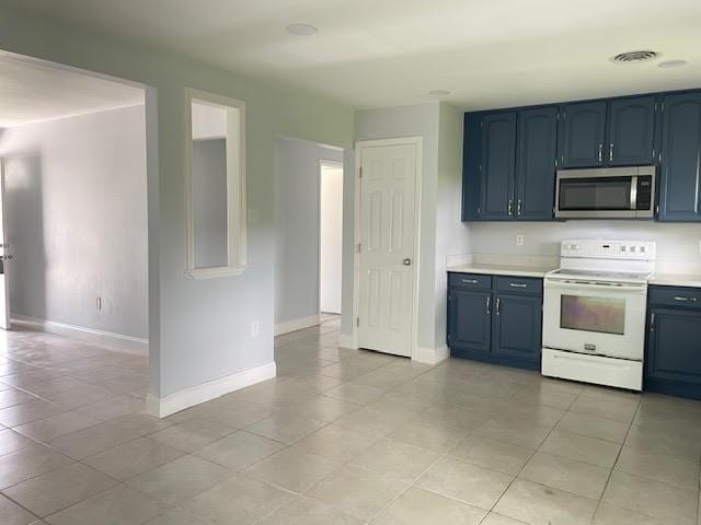 222 Adonis Way, Terrytown, LA 70056 - kitchen with electric stove, stainless steel microwave, blue cabinets, light countertops, and baseboards