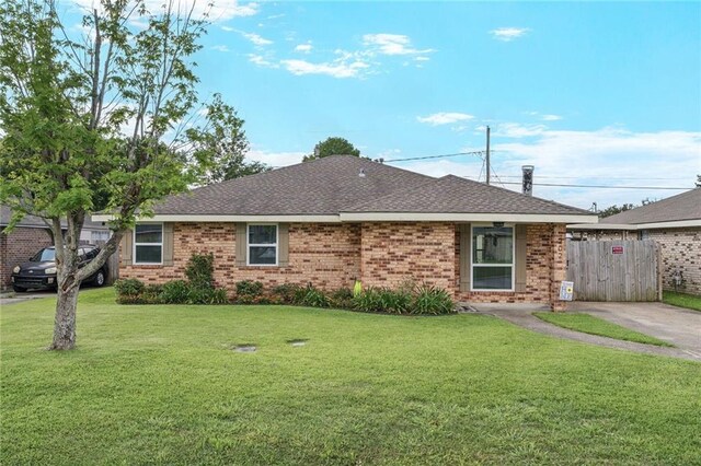 202 River Point Dr, Destrehan, LA 70047 - ranch-style home featuring brick siding, fence, a shingled roof, and a front yard