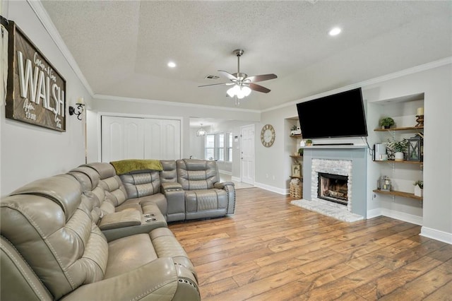 202 River Point Dr, Destrehan, LA 70047 - living room featuring a ceiling fan, a textured ceiling, wood finished floors, and ornamental molding