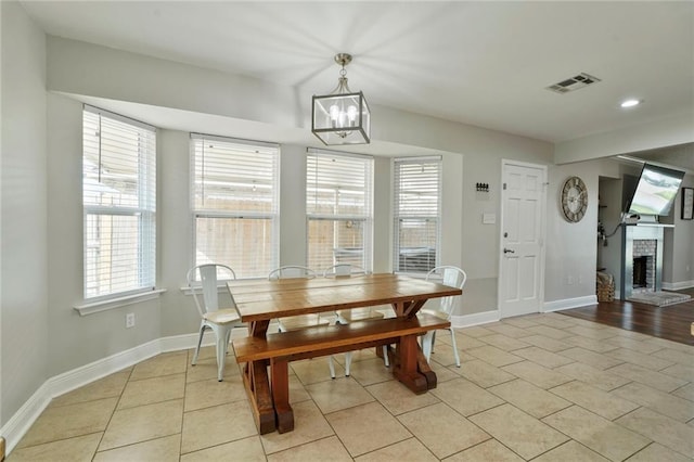 202 River Point Dr, Destrehan, LA 70047 - dining space with a chandelier, visible vents, a healthy amount of sunlight, and light tile patterned floors