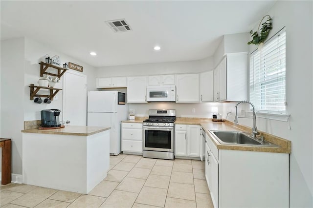 202 River Point Dr, Destrehan, LA 70047 - kitchen with visible vents, white appliances, white cabinetry, a sink, and light tile patterned floors