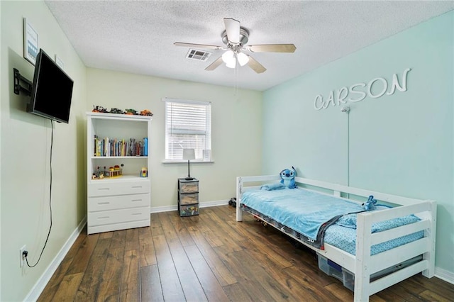 202 River Point Dr, Destrehan, LA 70047 - bedroom with visible vents, a textured ceiling, baseboards, and hardwood / wood-style floors