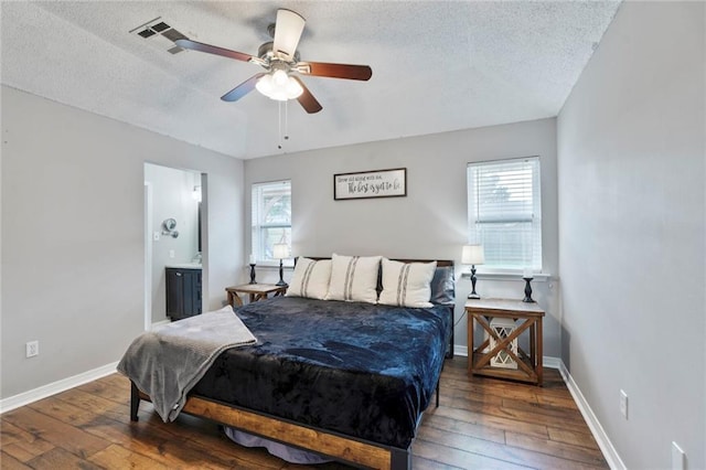202 River Point Dr, Destrehan, LA 70047 - bedroom featuring a textured ceiling, multiple windows, and hardwood / wood-style flooring