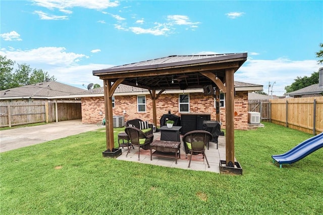 202 River Point Dr, Destrehan, LA 70047 - view of patio / terrace with central air condition unit, a gazebo, an outdoor living space, and a fenced backyard