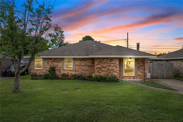 202 River Point Dr, Destrehan, LA 70047 - ranch-style house with fence, a shingled roof, brick siding, and a front yard
