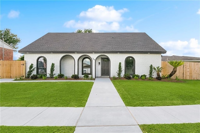 736 Glouster Pl, Gretna, LA 70056 - french country home featuring brick siding, a front yard, and roof with shingles