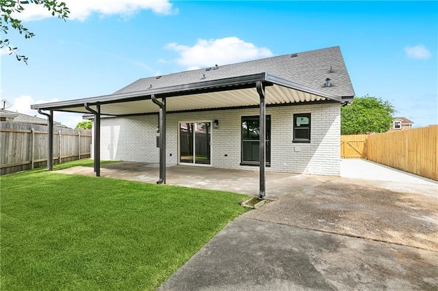 736 Glouster Pl, Gretna, LA 70056 - back of property with a lawn, a patio, brick siding, and a fenced backyard