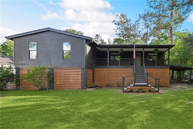 back of house featuring a yard and stairway