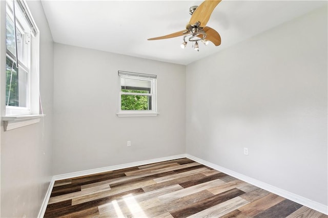 unfurnished room featuring baseboards, ceiling fan, and wood finished floors