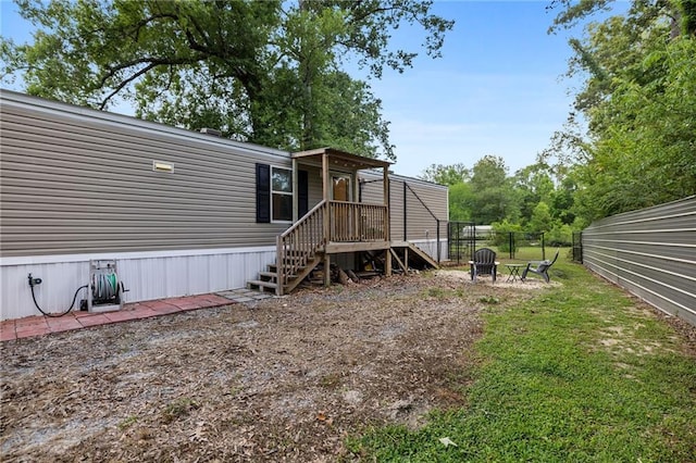 26272 Jim Bailey Rd, Holden, LA 70744 - exterior space featuring a lawn, an outdoor fire pit, and fence