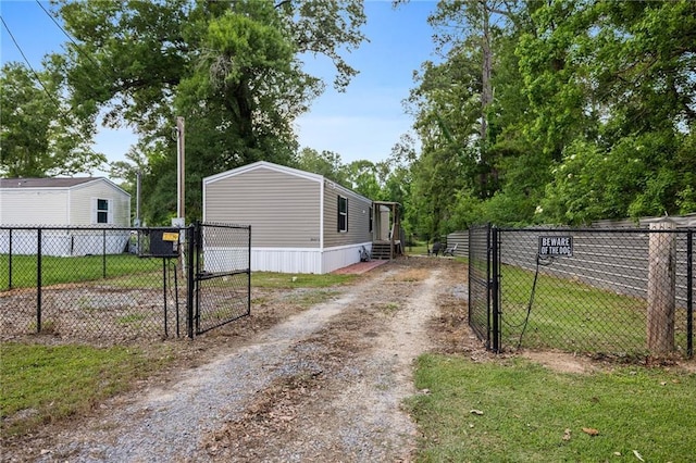 26272 Jim Bailey Rd, Holden, LA 70744 - view of road featuring entry steps, a gate, a gated entry, and dirt driveway