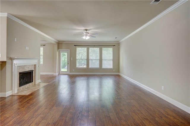 unfurnished living room featuring wood-type flooring, baseboards, ceiling fan, and a healthy amount of sunlight