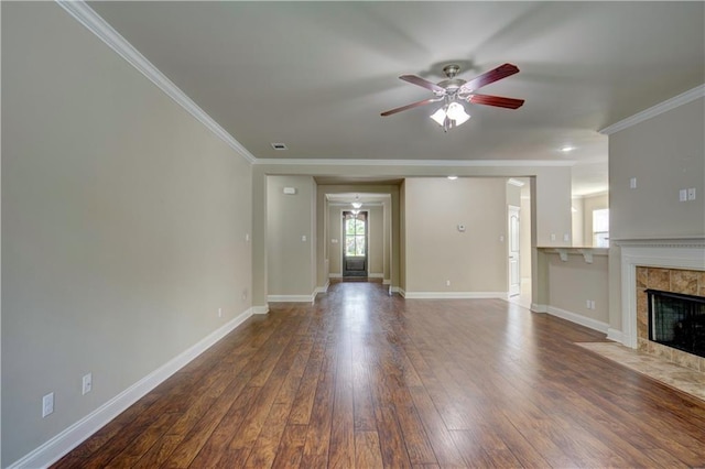 unfurnished living room with wood-type flooring, crown molding, baseboards, and ceiling fan