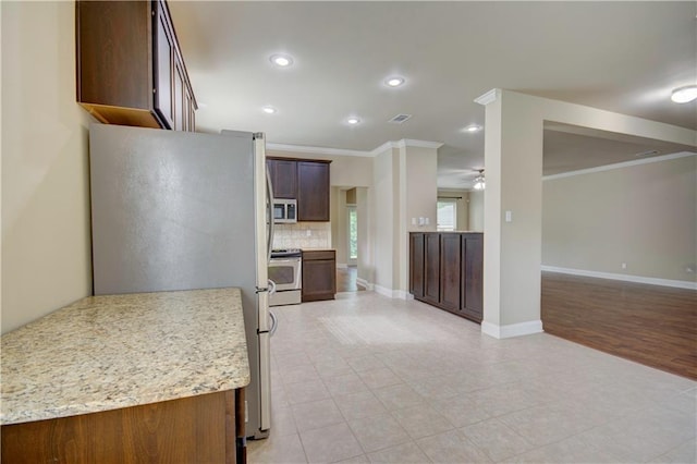 257 Long Leaf Ct, Ponchatoula, LA 70454 - kitchen featuring stainless steel appliances, crown molding, a ceiling fan, decorative backsplash, and recessed lighting