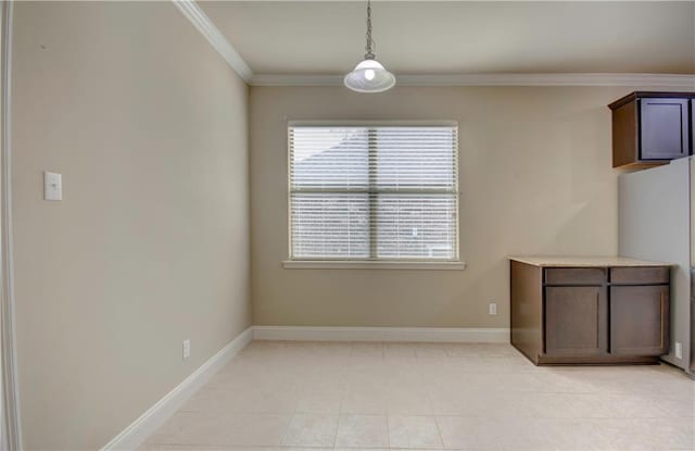 interior space featuring baseboards, ornamental molding, and light tile patterned flooring