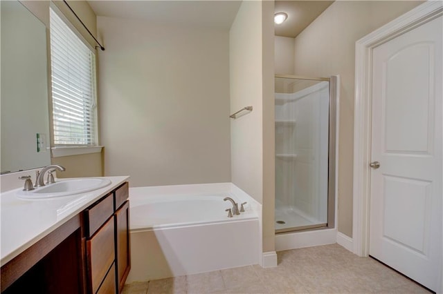 bathroom featuring vanity, tile patterned flooring, a bath, and a stall shower