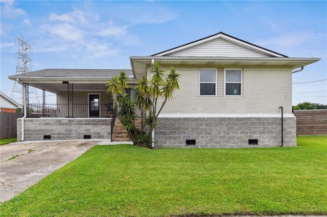 view of front of property with brick siding, crawl space, fence, and a front yard