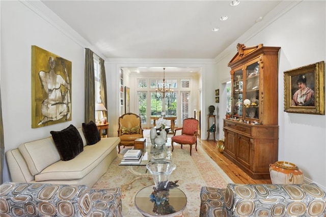 16407 Summerhill Rd, Covington, LA 70435 - living room with a chandelier, light wood-style flooring, and ornamental molding
