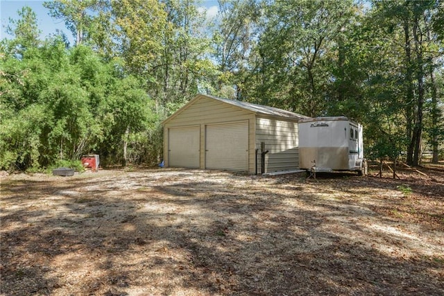 16407 Summerhill Rd, Covington, LA 70435 - detached garage featuring view of wooded area