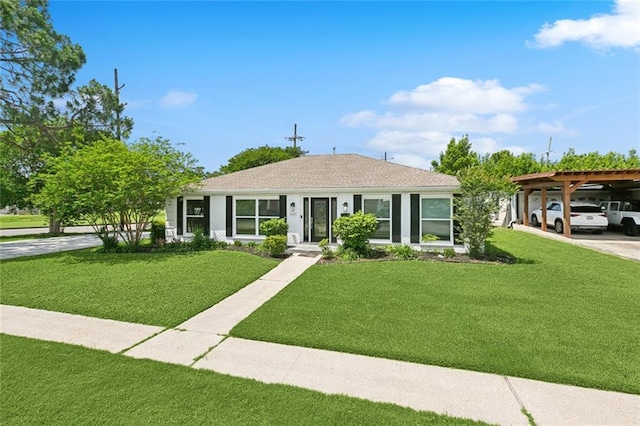 bungalow-style house with a front lawn, driveway, and a carport