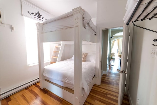 1418 Kerlerec St, New Orleans, LA 70116 - bedroom with a baseboard radiator and light wood finished floors